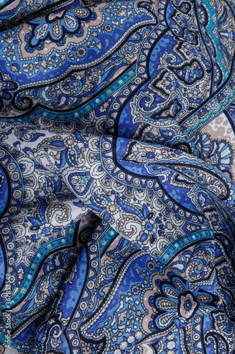 Obraz na płótnie top view closeup on crumpled blue cotton scarf with bright oriental ornament w salonie
