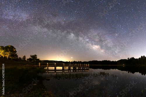 Milky way galaxy and wooden pier at Lake Cuyamaca in San Diego County, California photo