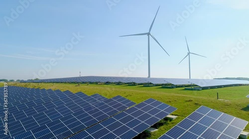 AERIAL WS Sheep in field with solar panels and wind turbines / Geldermalsen, Gelderland, Netherlands