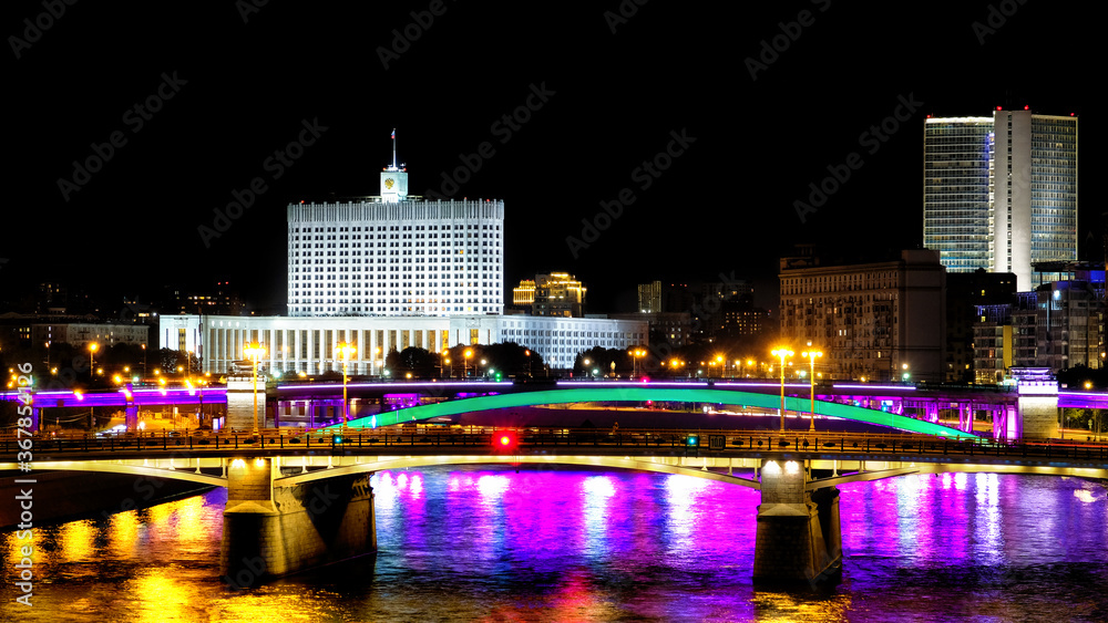 downtown moscow city at night modern architecture landmark with russian government white house building lights reflection on moscow river water against black sky background. Street view. Wide panorama downtown moscow city at night modern architecture landmark with russian government white house building lights reflection on moscow river water against black sky background. Street view. Wide panorama