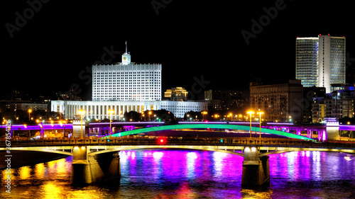 downtown moscow city at night modern architecture landmark with russian government white house building lights reflection on moscow river water against black sky background. Street view. Wide panorama