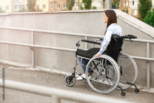 Young woman in wheelchair outdoors © Pixel-Shot