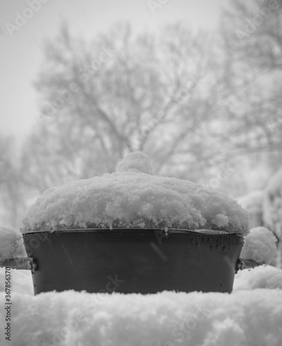 cast iron pot covered with snow