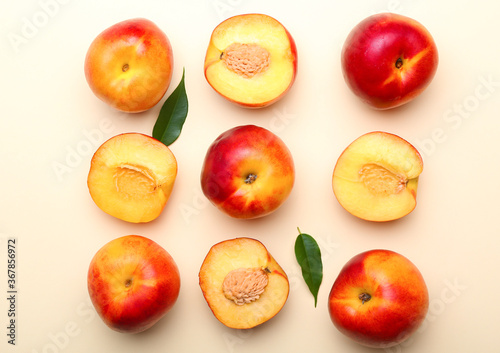Sweet ripe nectarines on color background