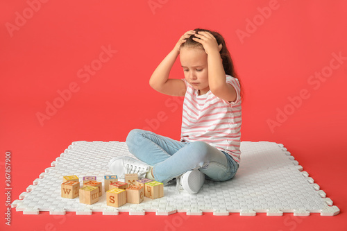 Sad little girl with autist...