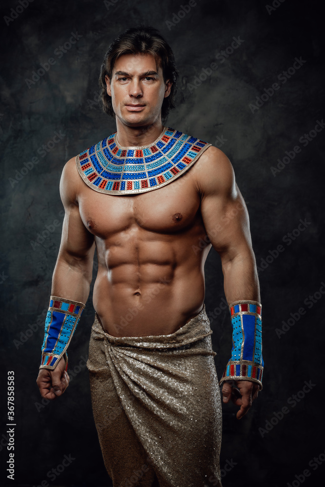 Athletic man in ancient egyptian costume posing in the studio with ...
