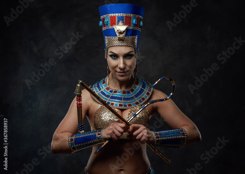 фотографія Beautiful woman in egyptian blue and gold costume with some red details