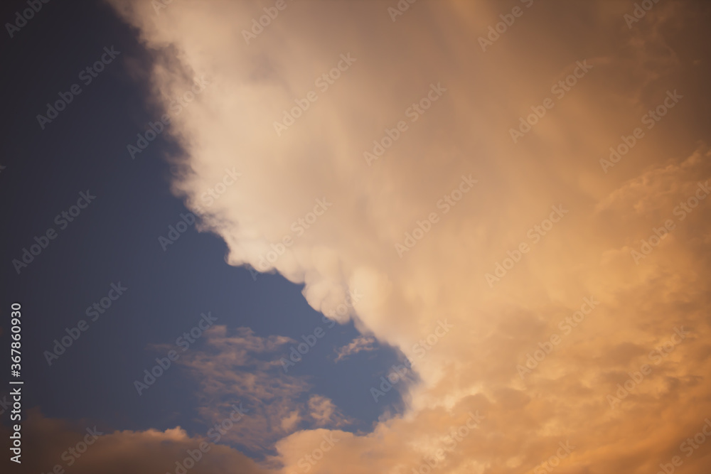 Evening clouds against the blue sky