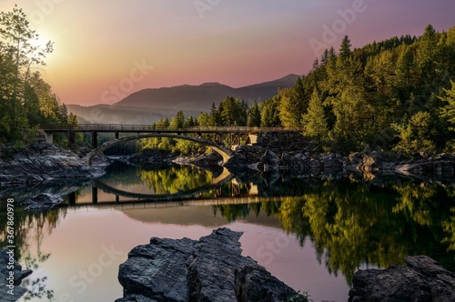 A sunrise across Belton Bridge over Middle Fork Flathead River near West Glacier in Glacier National Park, Montana, USA