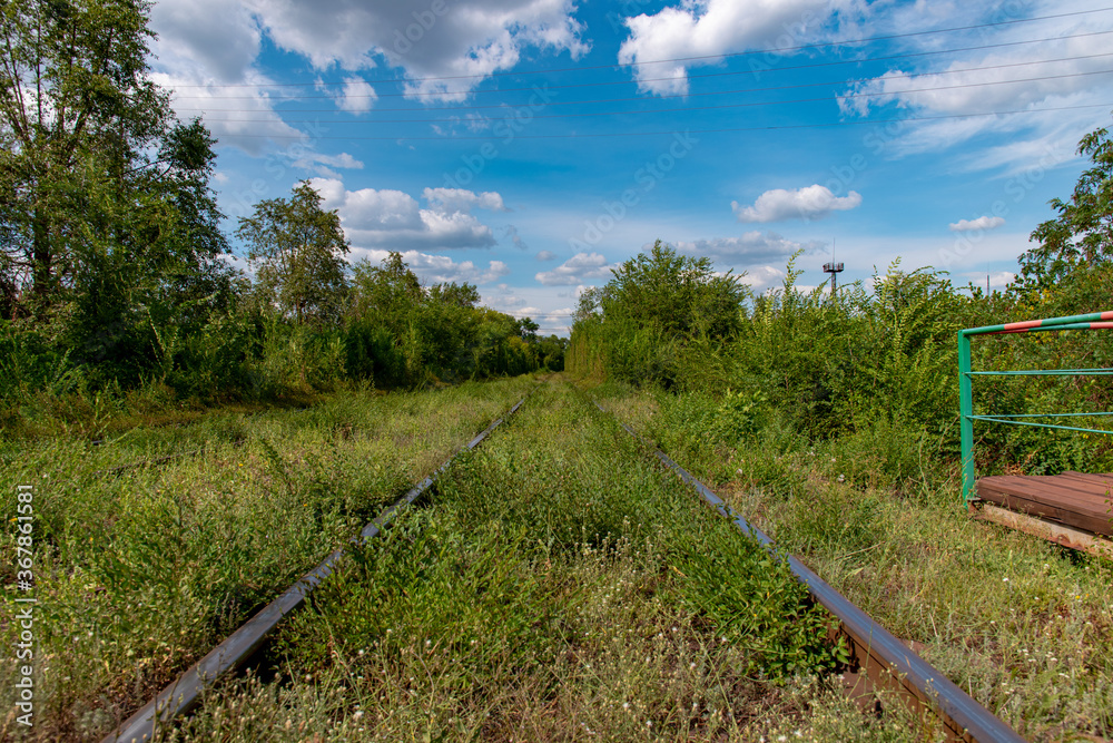 Ukraine, Krivoy Rog, the 16 of July 2020. Rarely used rail tracks near the town park.