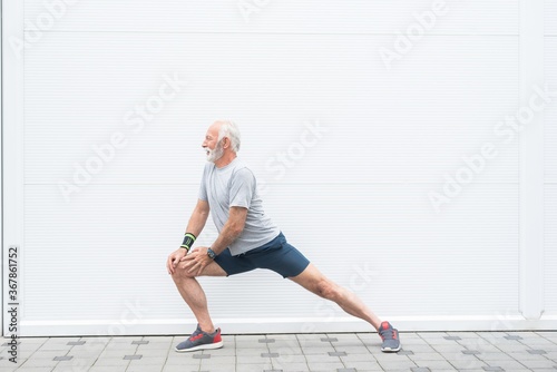 Senior man stretching legs before workout