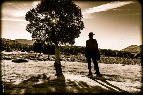 the silhouette of a cowboy at the Sad Hill Cemetery in Contreras at sunrise (Santo Domingo de Silos), province of Burgos, Castile and Leon, Spain photo