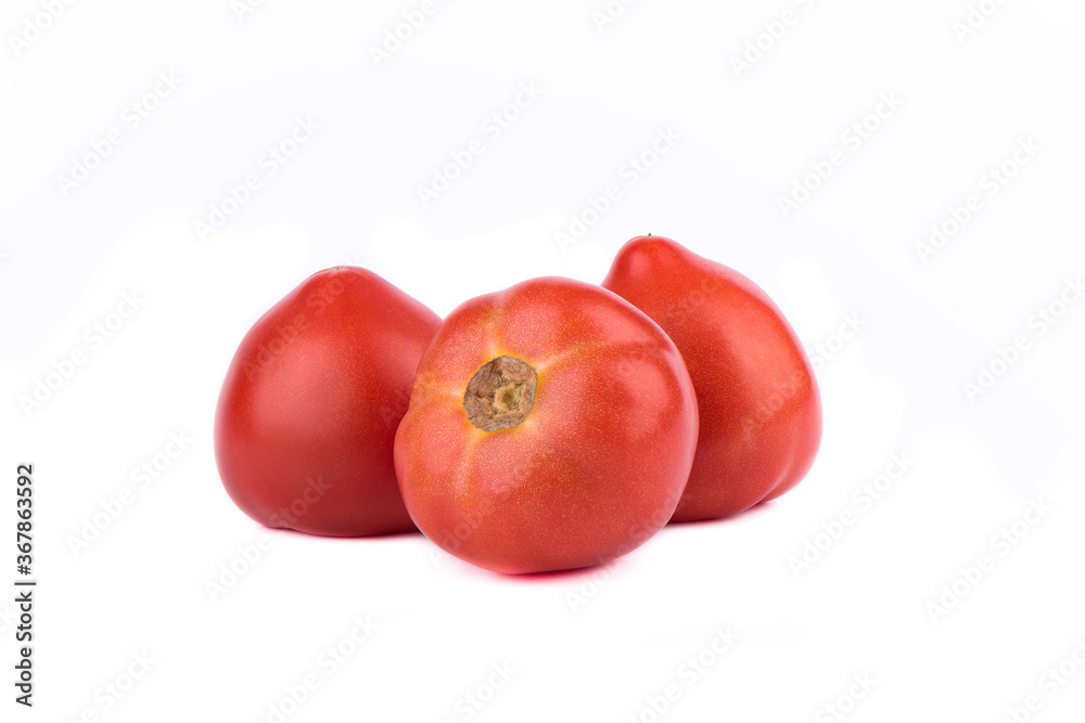 Three ripe red tomatoes are isolated on a white background. Three ripe red tomatoes are isolated on a white background.