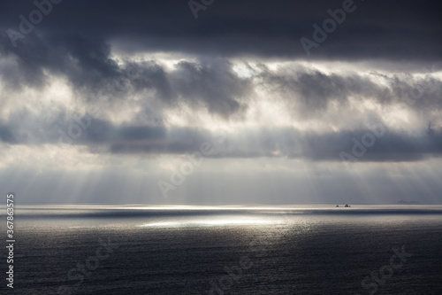rays of sun through the clouds over ocean