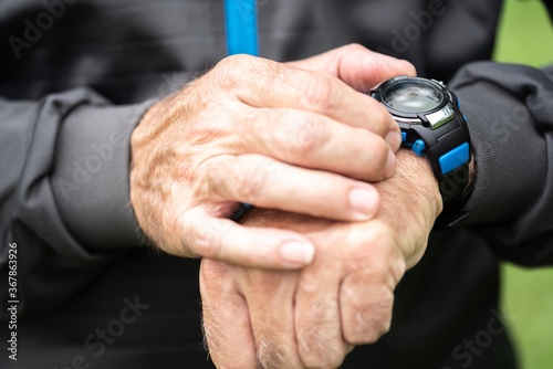 Man adjusting settings of sportswatch for outdoor training