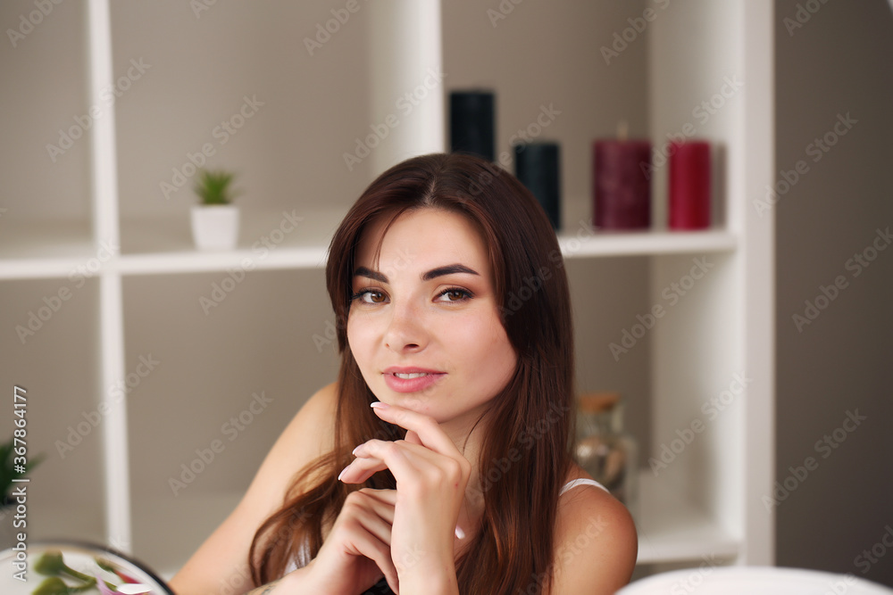 young beautiful brunette skin care near the mirror at home young beautiful brunette skin care near the mirror at home