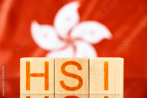 hsi index hong kong. wooden blocks with hsi lettering on hong kong flag background photo