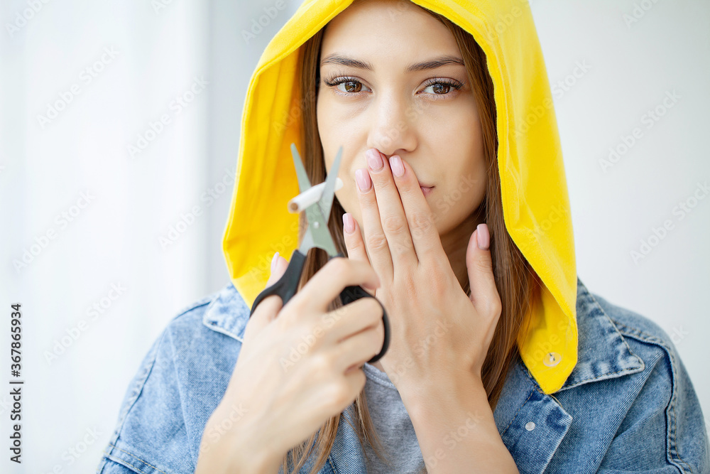 Stop smoking, woman cuts a cigarette with scissors