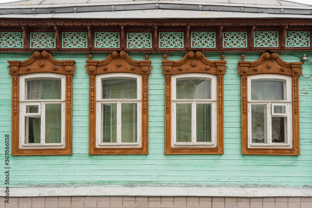 old window in the old town of kolomna russia. wooden house with beautiful carved platbands old window in the old town of kolomna russia. wooden house with beautiful carved platbands