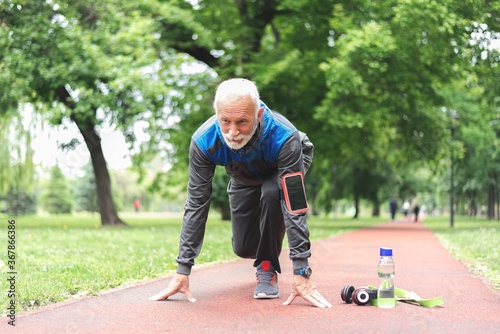 Confident sportsman in starting position ready for running