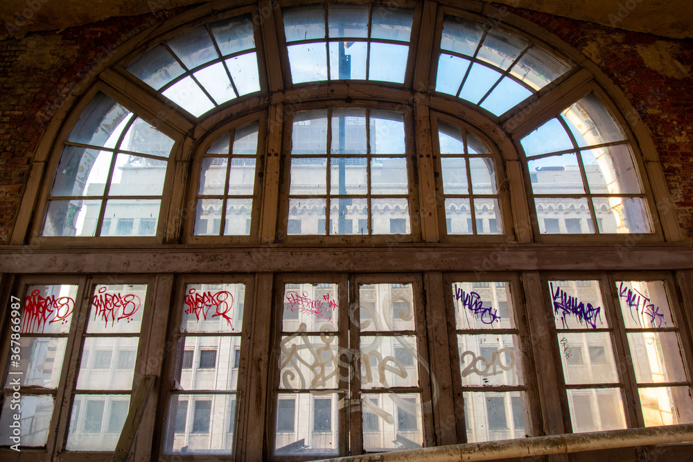 A Large Arched Window in an Abandoned Building