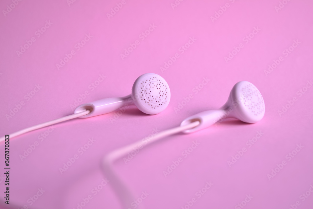 close up of earphone on pink close up of earphone on pink