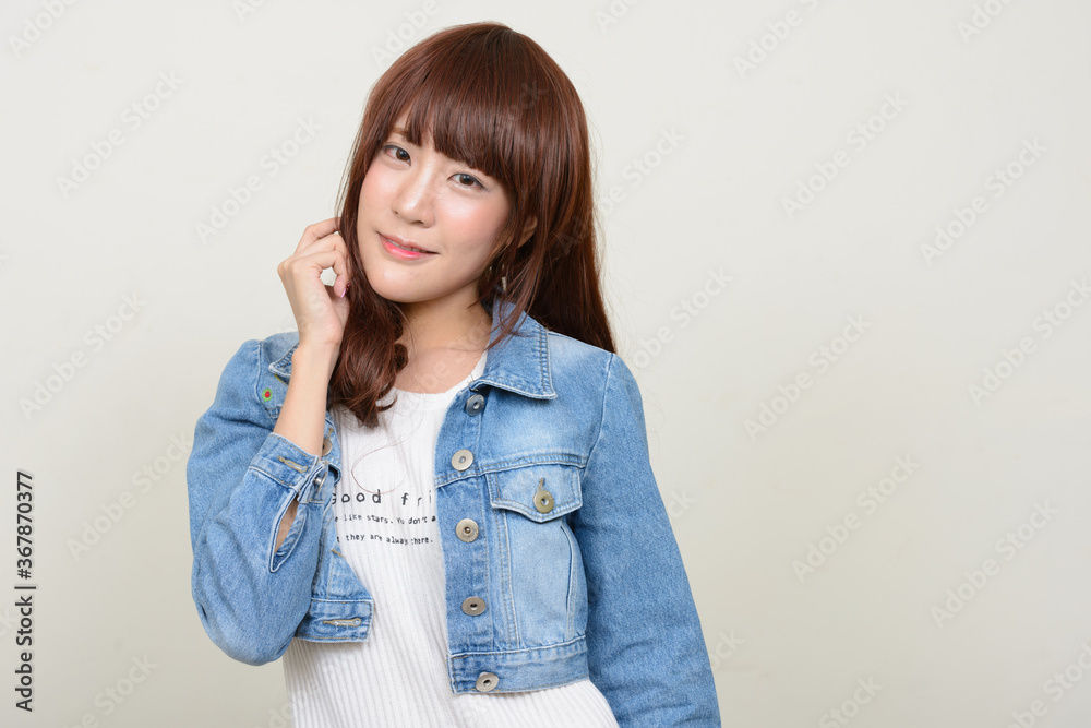 Portrait of young beautiful Asian woman wearing wig Portrait of young beautiful Asian woman wearing wig