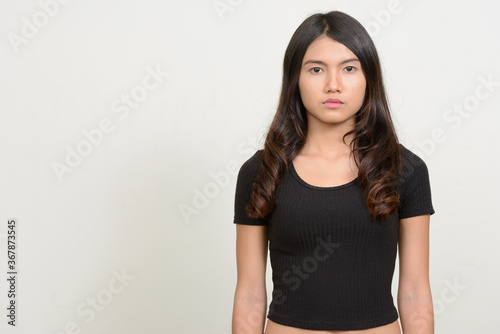 Portrait of young beautiful Asian woman looking at camera