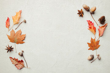 Autumn season abstract background. Fall yellow leaves frame on stone surface. Thanksgiving day, seasonal concept. Copy space.