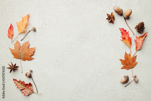 Autumn season abstract background. Fall yellow leaves frame on stone surface. Thanksgiving day, seasonal concept. Copy space. photo