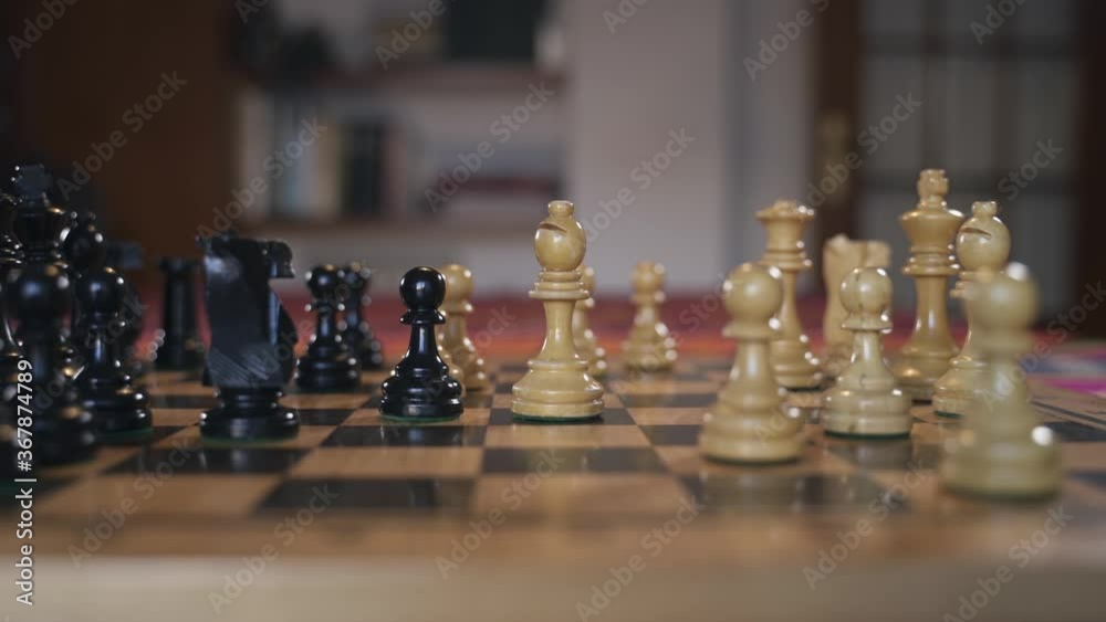 Hands of man playing chess moves a Horse and kills Bishop. Concept for business, strategy and competition Hands of man playing chess moves a Horse and kills Bishop. Concept for business, strategy and competition