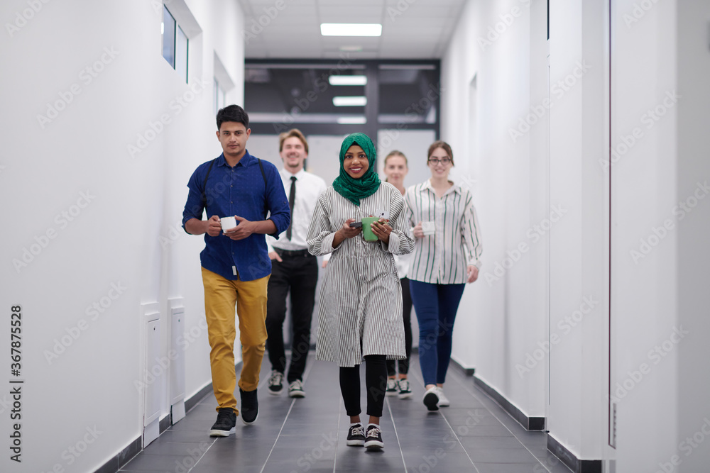 multi-ethnic startup business team walking through the hallway multi-ethnic startup business team walking through the hallway