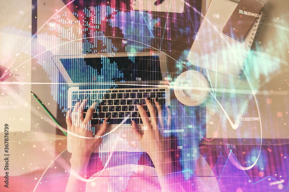 Double exposure of woman hands working on computer and financial theme hologram drawing. Top View. Business concept. Double exposure of woman hands working on computer and financial theme hologram drawing. Top View. Business concept.