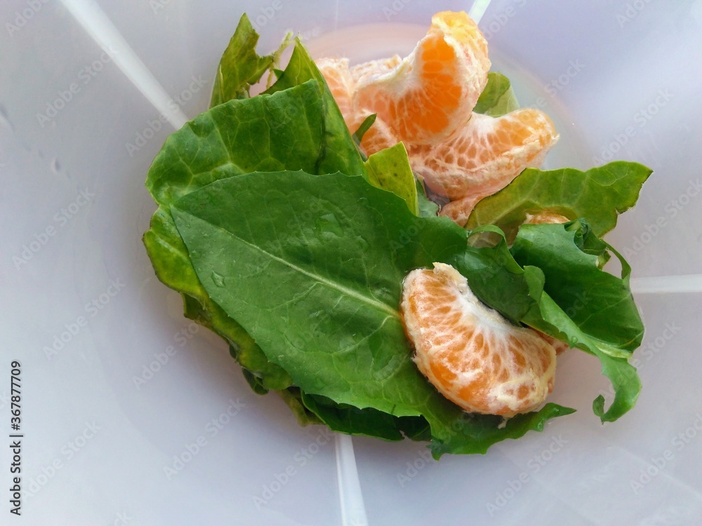 tangerine and vegetables in cup tangerine and vegetables in cup