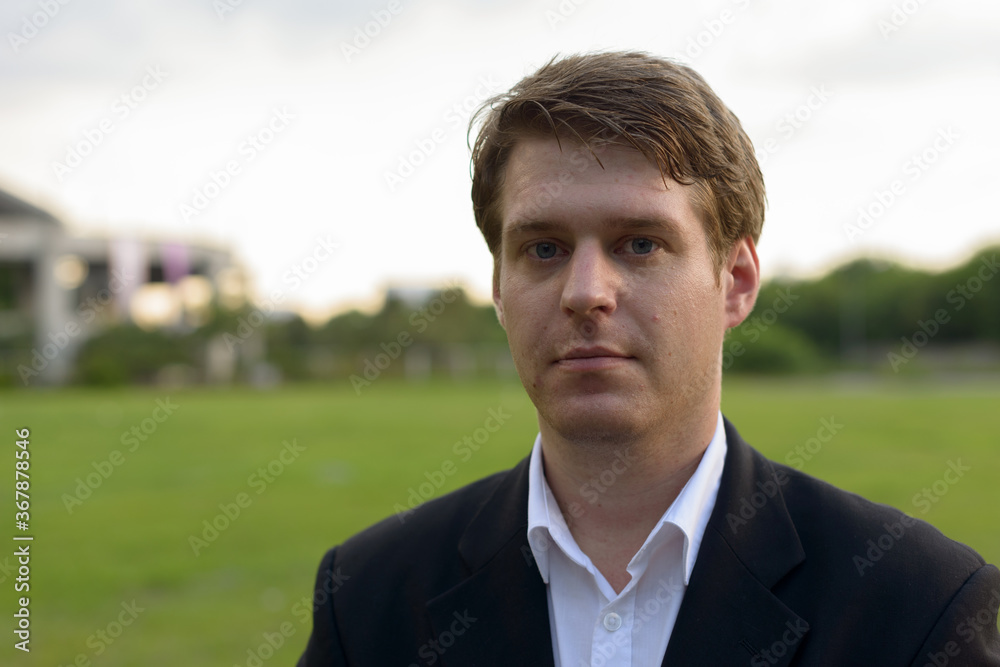 Portrait of young handsome businessman at the park Portrait of young handsome businessman at the park