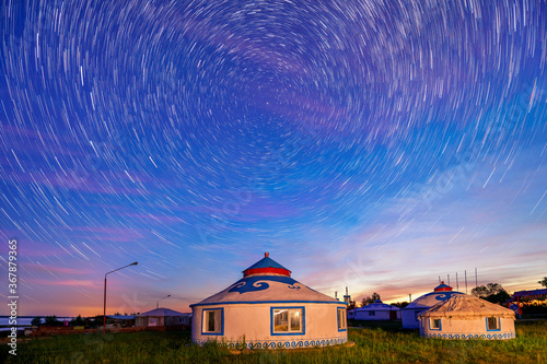 The mongolia yurts under the starry sky in the night. photo