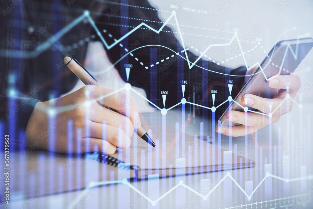 Double exposure of forex graph sketch hologram and woman holding and using a mobile device. Stock market concept. Double exposure of forex graph sketch hologram and woman holding and using a mobile device. Stock market concept.