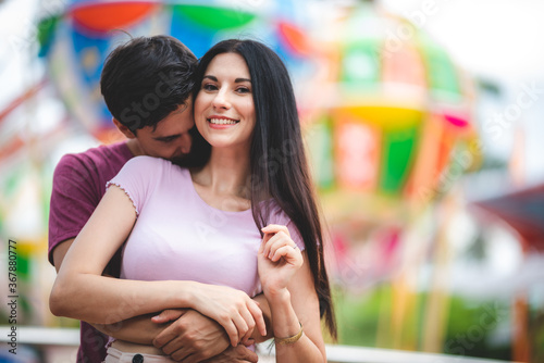 romantic lover couple embracing hug at amusement park, dating at theme park © chokniti