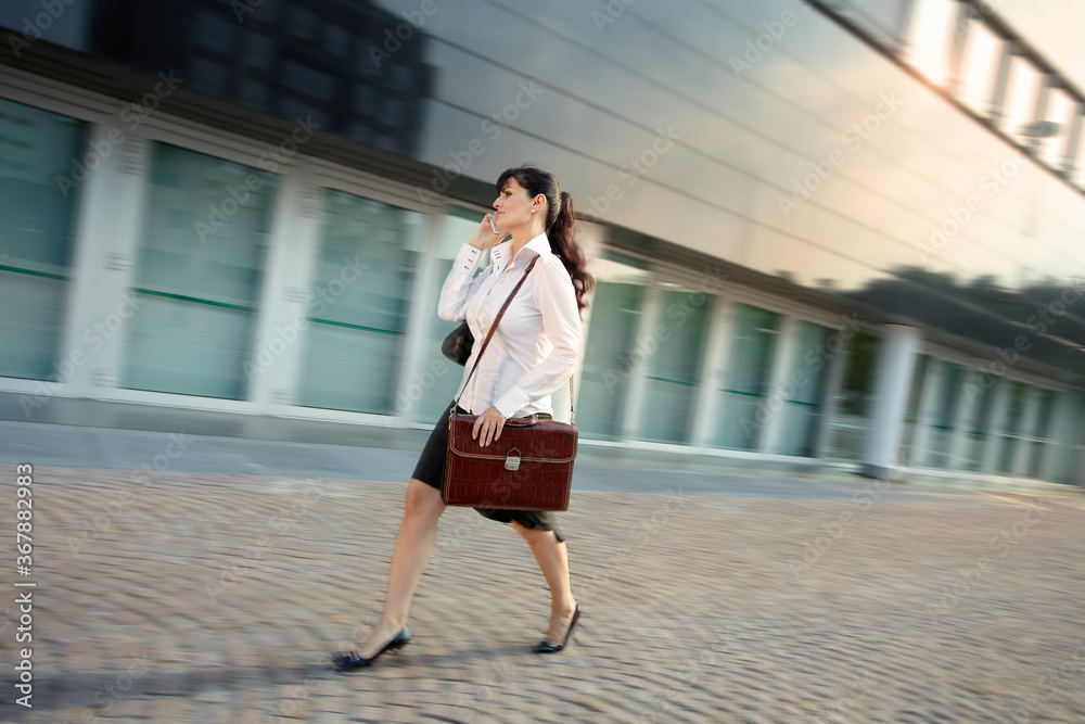 Mature Woman Arriving Late To Office Walking Fast On Street