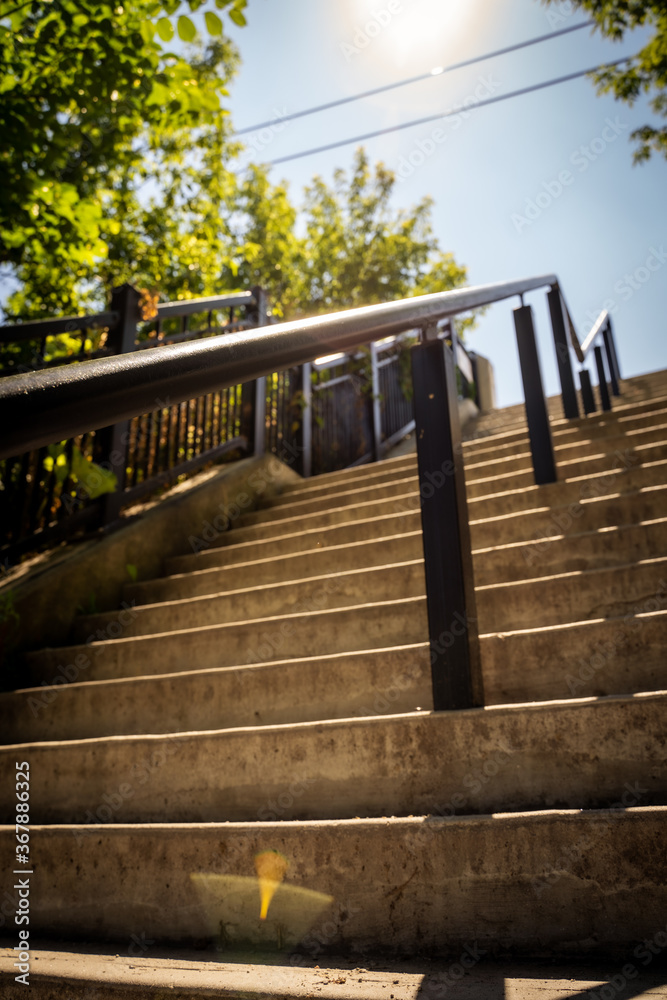 Fototapeta premium Looking up the stairs with sunbam