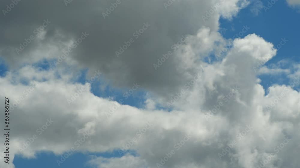 Fluffy clouds floating through a summers blue sky, close up. Realtime. 4K Fluffy clouds floating through a summers blue sky, close up. Realtime. 4K