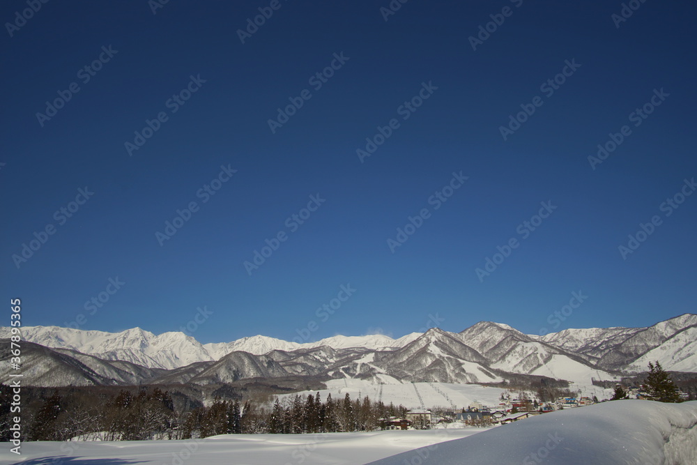 Fototapeta premium Daytime shot of snowed mountains in northern alps of Japan, Hakuba