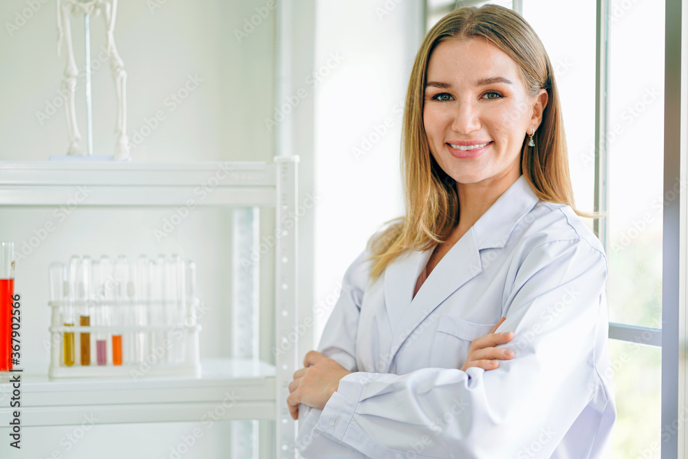 Smiling female doctor in lab coat with arms crossed against. Smiling female doctor in lab coat with arms crossed against.