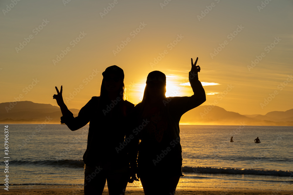 portrait two girls on beach, and golden sunset view background from NSW, Australia, Sydney 2018