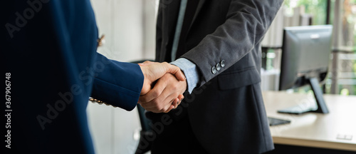 Business people shaking hand together in the office.