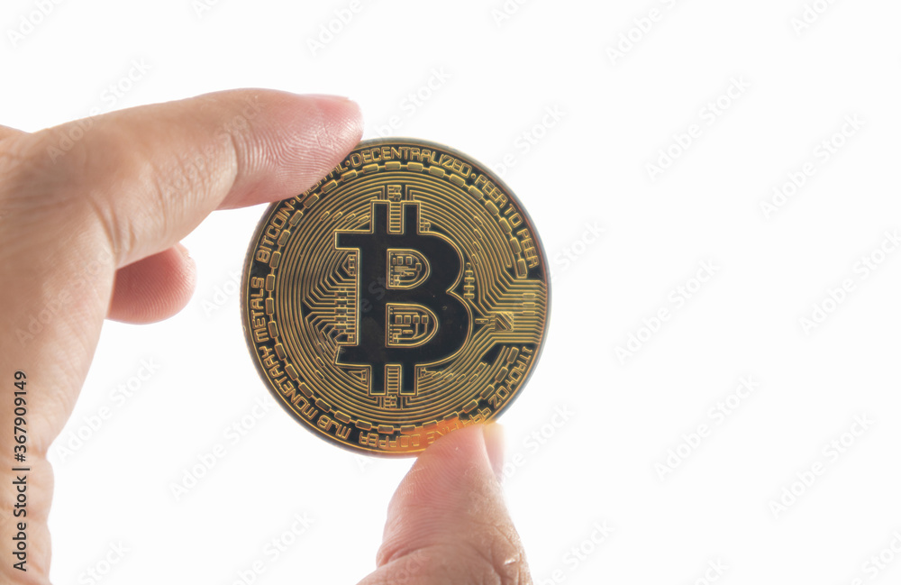 Bitcoin holding in hand isolated on white background with clipping path. Bitcoin holding in hand isolated on white background with clipping path.