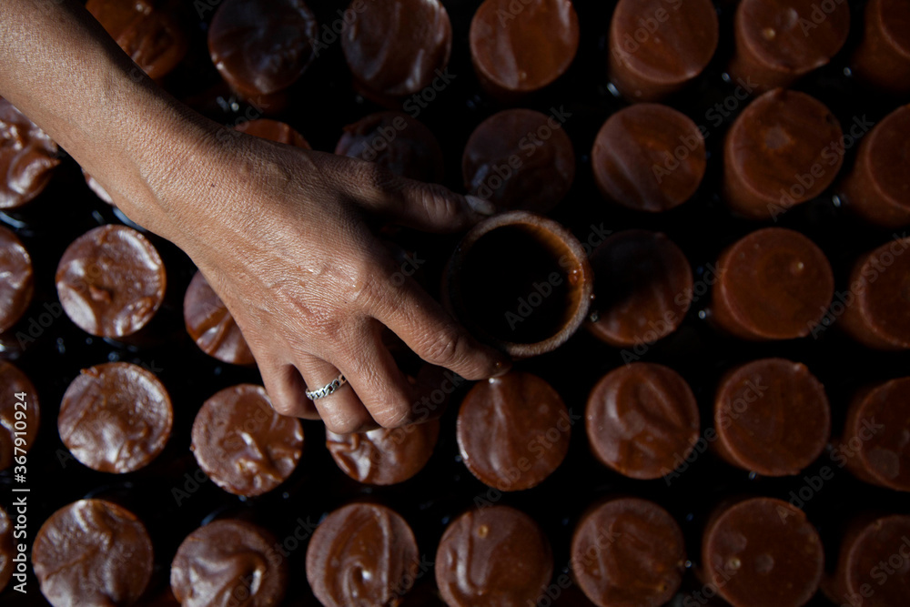 A resident prints sap water from palm trees that have been cooked and thick into bamboo molds, to be used as brown sugar in the traditional way A resident prints sap water from palm trees that have been cooked and thick into bamboo molds, to be used as brown sugar in the traditional way