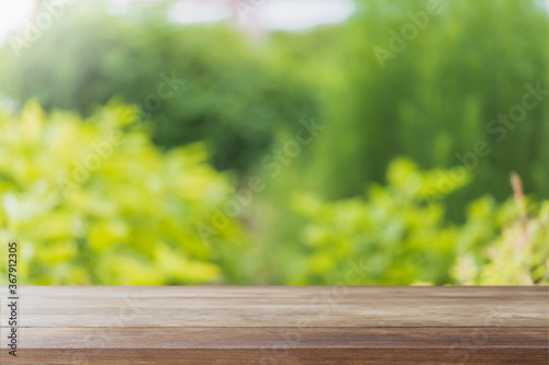Fotografie Empty wood table top and blurred green tree and vegetable in agricultural farms
