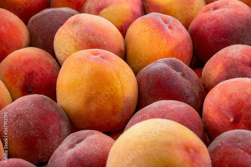 Background and texture of ripe peaches. Close-up.