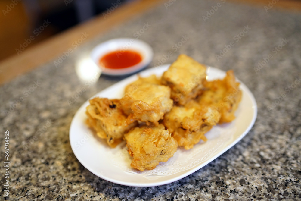 Deep fried homemade tofu with water chestnuts and mushrooms served with dipping sauce of chili and chinese coriander. Deep fried homemade tofu with water chestnuts and mushrooms served with dipping sauce of chili and chinese coriander.
